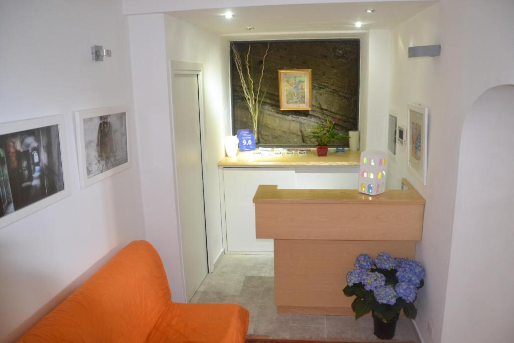 a room with a desk and a window with flowers at Terra Murata Boutique b&b in Procida