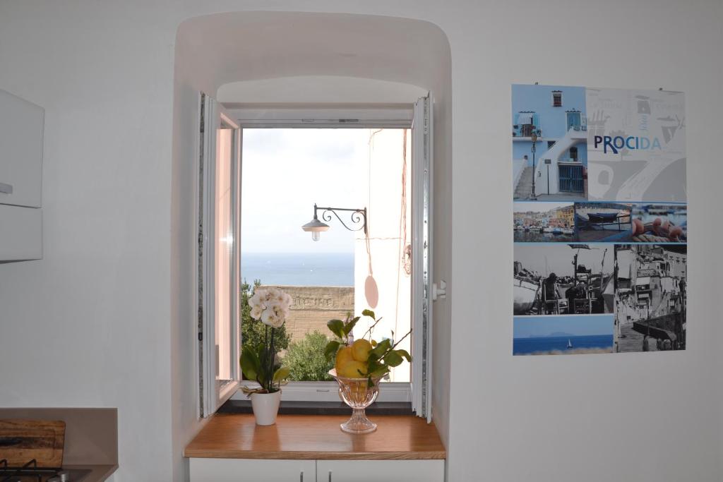 a window with a vase on a table in a room at Terra Murata Boutique b&b in Procida