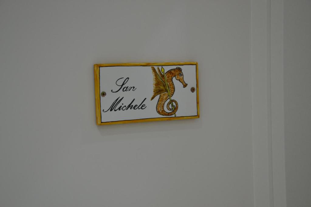 a picture of a lizard in a frame on a wall at Terra Murata Boutique b&b in Procida