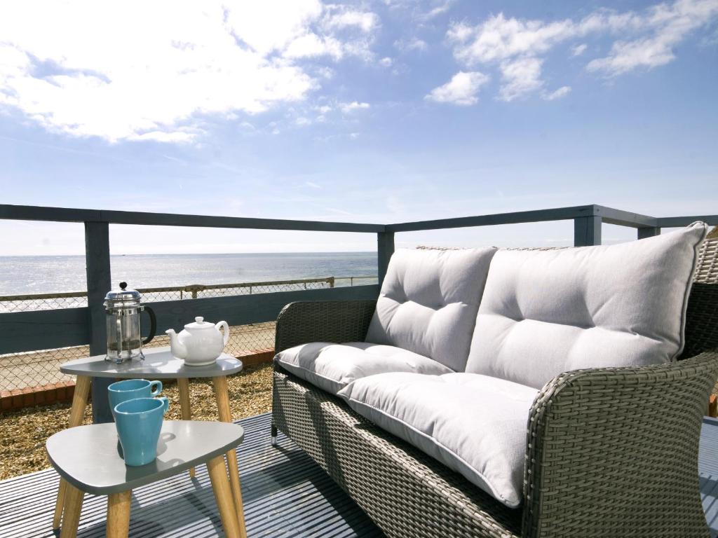 ein Wohnzimmer mit einem Sofa und Strandblick in der Unterkunft Sail Away Holiday Villa in Ventnor