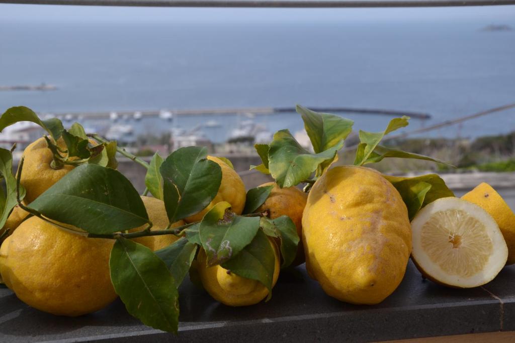 a pile of lemons sitting on a table at Terra Murata Boutique b&b in Procida