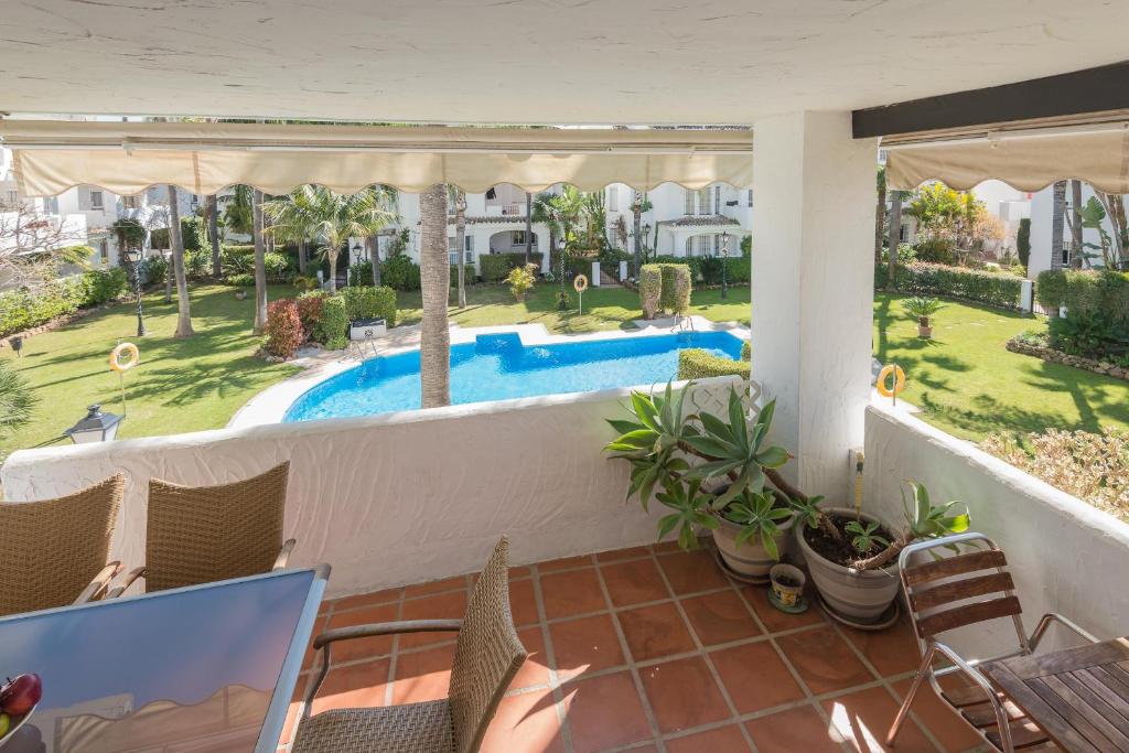 a balcony with a view of a swimming pool at Bello Naranjo, Puerto Banus Los naranjos de Marbella in Marbella
