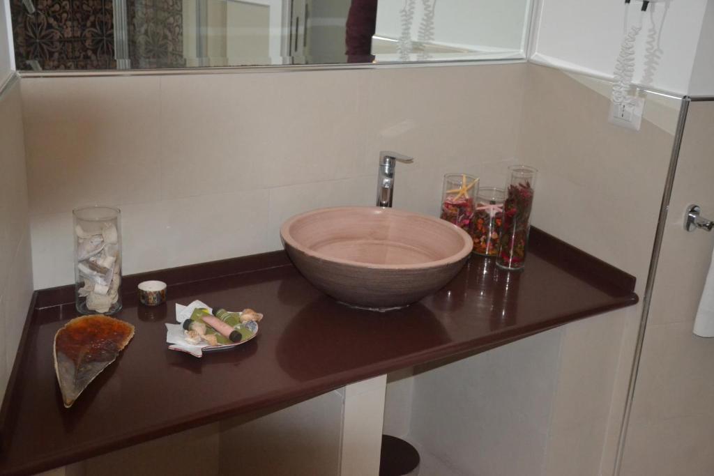 a bathroom with a bowl sink on a counter at Terra Murata Boutique b&b in Procida