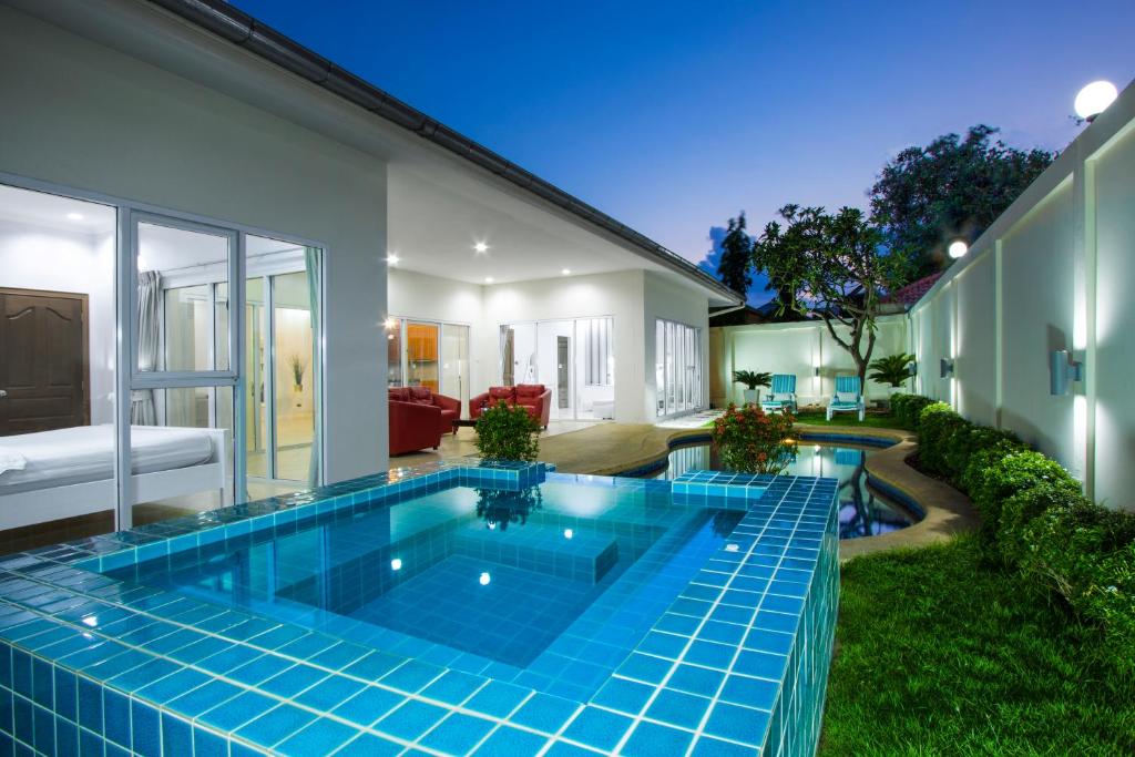 a swimming pool in the backyard of a house at Tortuga Villas Pattaya in Pattaya South