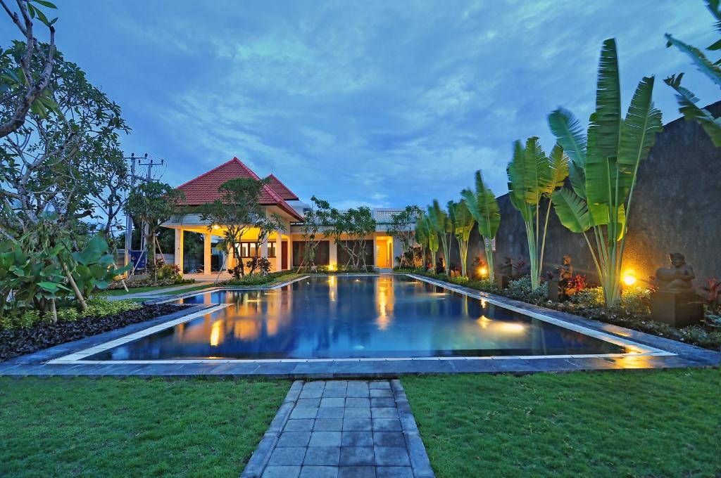 a swimming pool in the yard of a house at Taman Ayu Town House in Denpasar