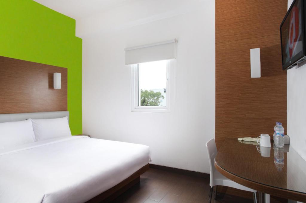 Postel nebo postele na pokoji v ubytování Amaris Hotel Malang