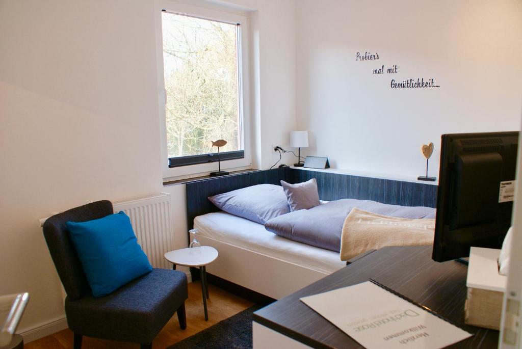 a living room with a couch and a window at Deichhotel Rose in Juist