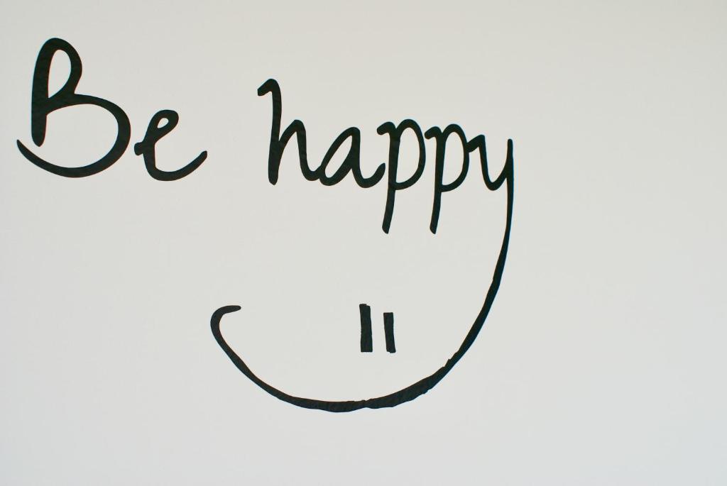 a vector illustration of be happy it handwritten in calligraphy at Deichhotel Rose in Juist