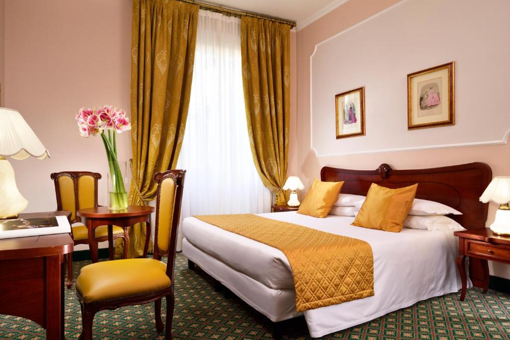Postel nebo postele na pokoji v ubytování Hotel Berchielli