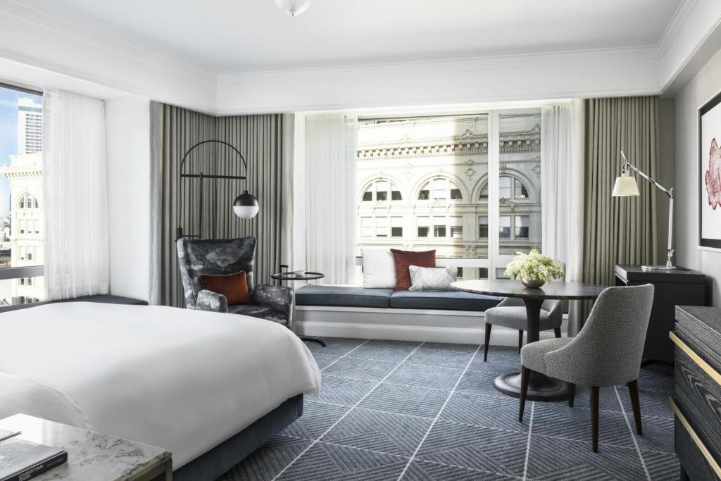 a bedroom with a bed and a living room at Four Seasons Hotel San Francisco in San Francisco