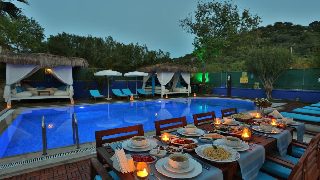 a table with food on it next to a swimming pool at B&B Boutique Hotel in Dalyan