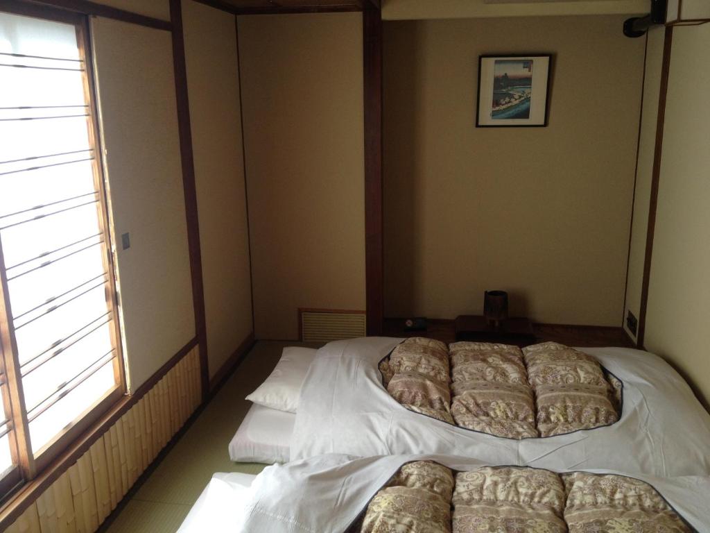 Postel nebo postele na pokoji v ubytování Hotel Edoya