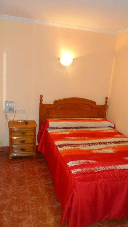 A bed or beds in a room at Hostal La Nava