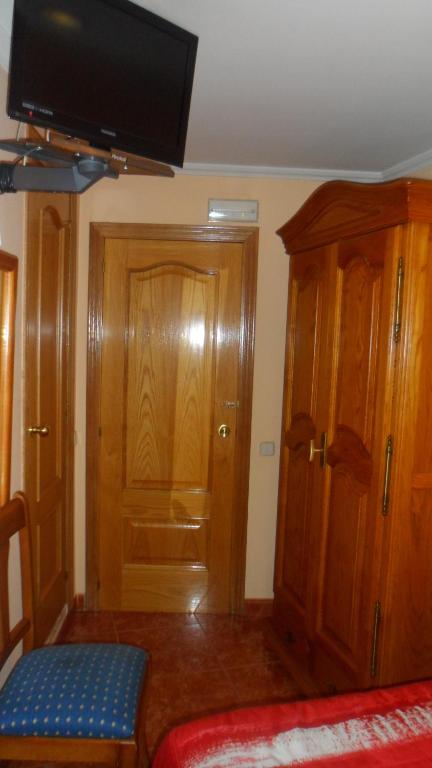 A bed or beds in a room at Hostal La Nava