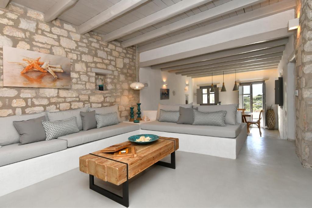 a living room with couches and a table at Sand Key Villa 2 in Santa Maria