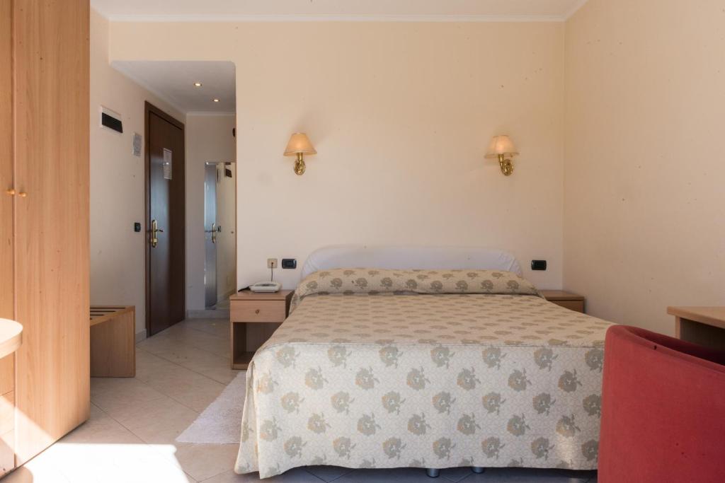 Postel nebo postele na pokoji v ubytování Hotel Stella