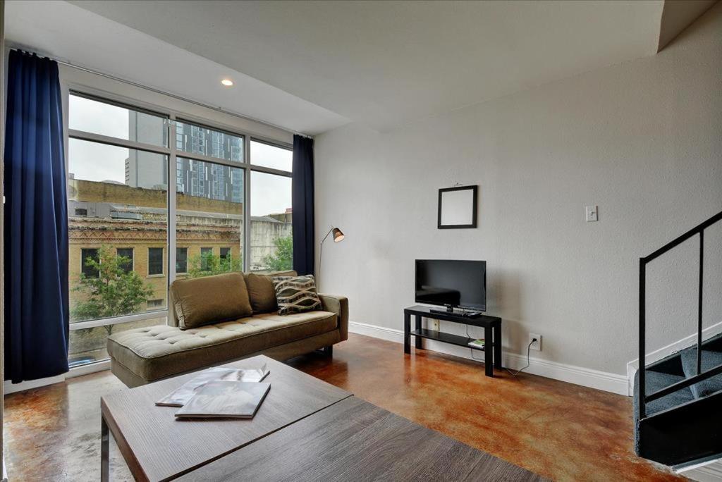a living room with a couch and a tv at Littlefield Lofts #302 in Austin