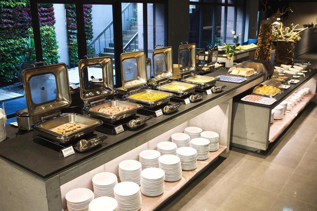 a buffet line with plates of food on display at Chiayi Guanzhi Hotel in Chiayi City