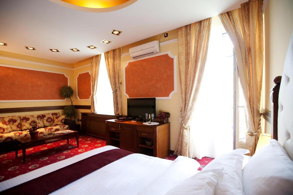 a hotel room with a bed and a desk at Manjež Centar in Belgrade