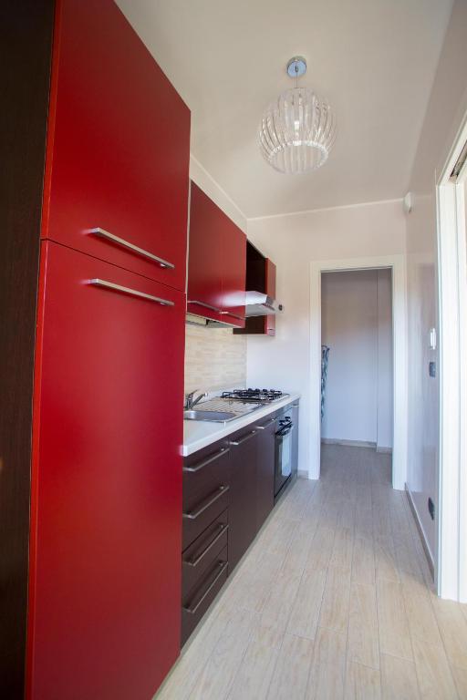 a kitchen with red cabinets and a red refrigerator at Green House in Barletta
