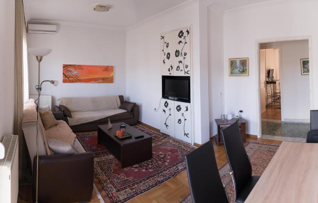 a living room with a couch and a table at Leo Lux Apartment in Kavála