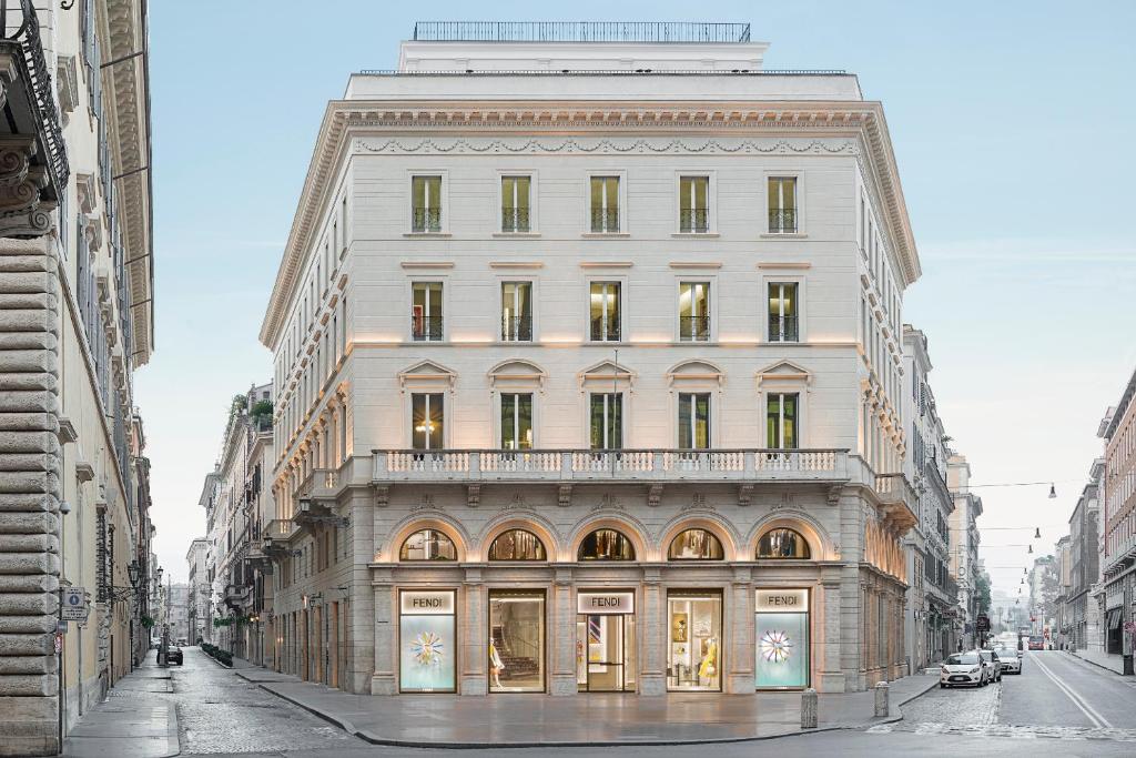 a large white building on a city street at Fendi Private Suites in Rome