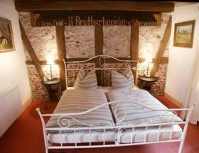 A bed or beds in a room at Pension Picco-Bello