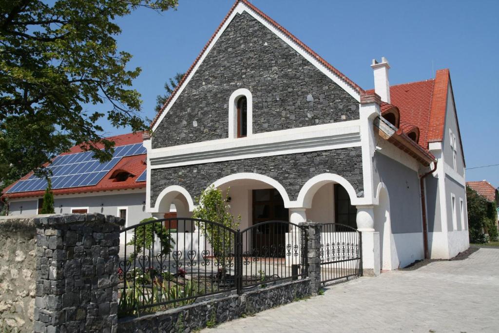 a church with a black fence in front of it at BASALTINA Panzió in Balatonederics