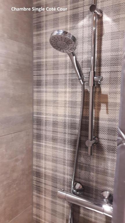 a shower with a shower head in a bathroom at Hôtel Les Brises in La Rochelle