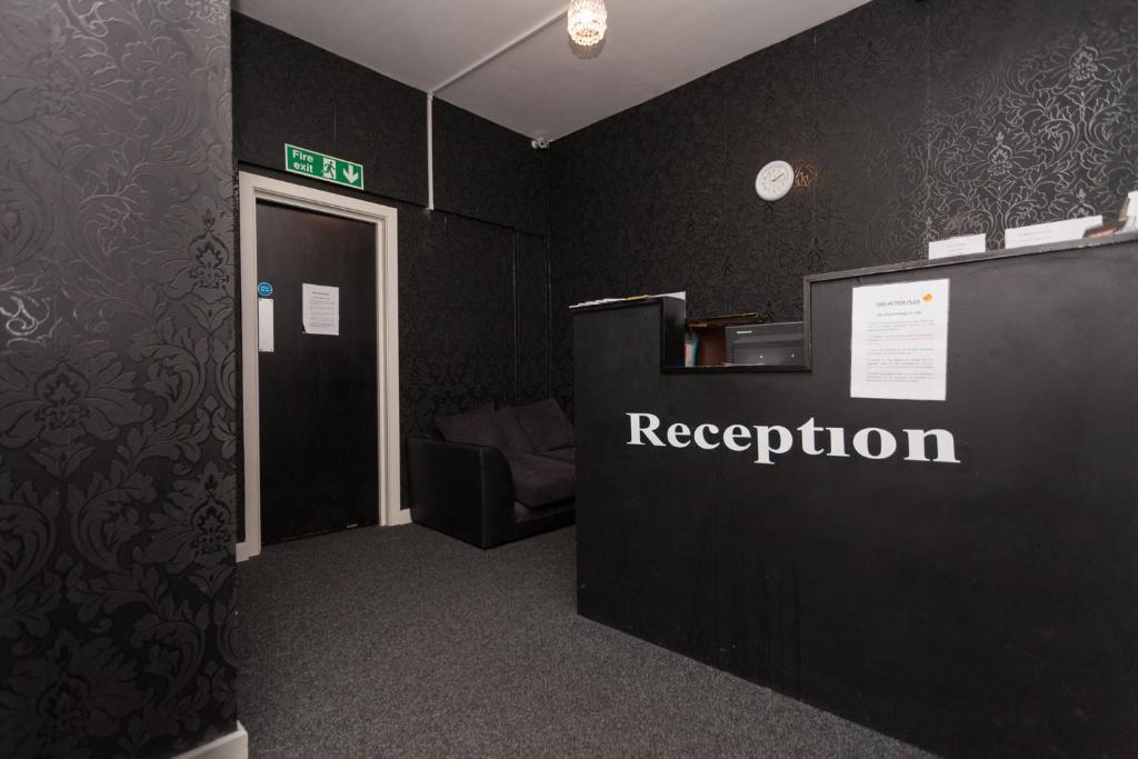 a room with a reception sign on a wall at Budget Hostel in Newcastle upon Tyne