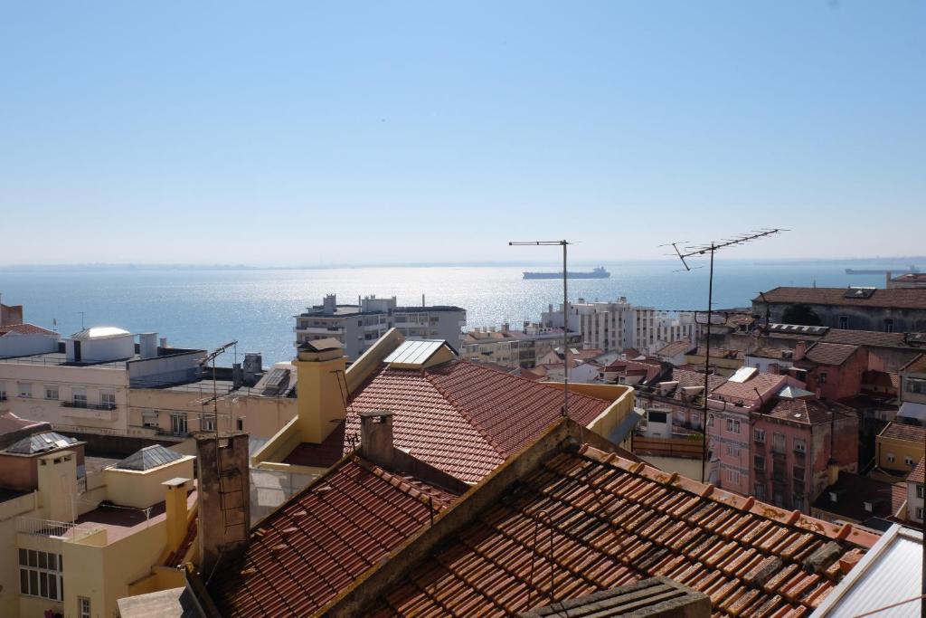 a city with buildings and the ocean in the background at Luz do Rio in Lisbon
