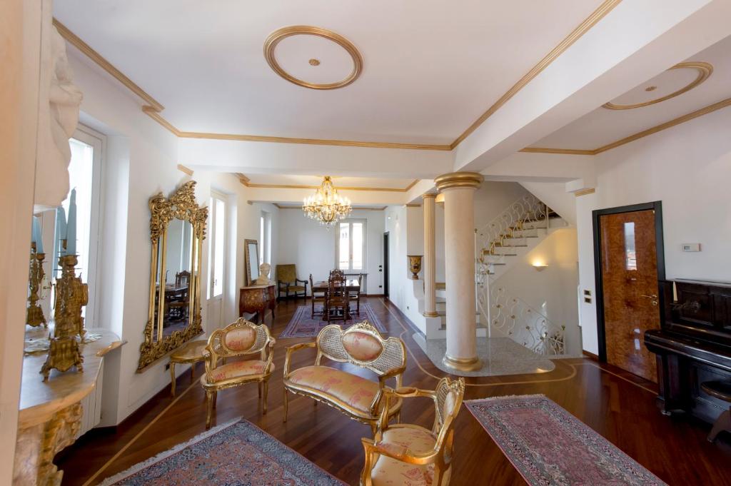 a living room with chairs and a piano at Villa Puccini Bed & Breakfast in Lecco