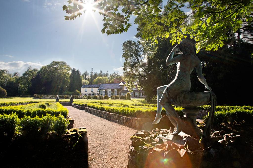 a statue of a woman sitting on a fountain in a garden at Virginia Park Lodge in Virginia