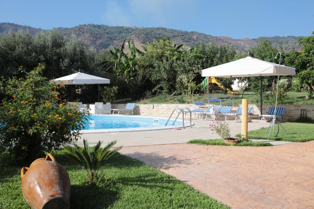 a swimming pool in a yard with at Hotel Maremonti in Ioppolo