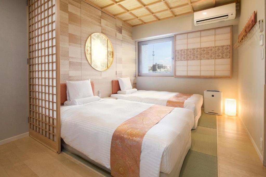 a hotel room with a bed and two lamps at HOTEL MYSTAYS Asakusabashi in Tokyo