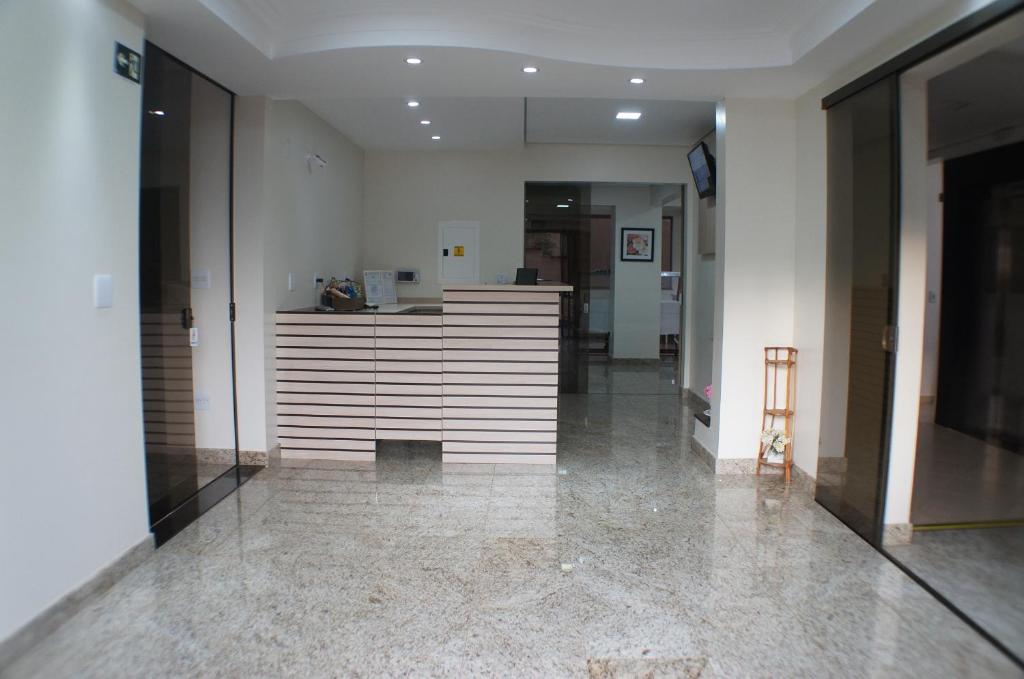 an empty hallway with a counter in a building at Hotel Harmonia in Araras