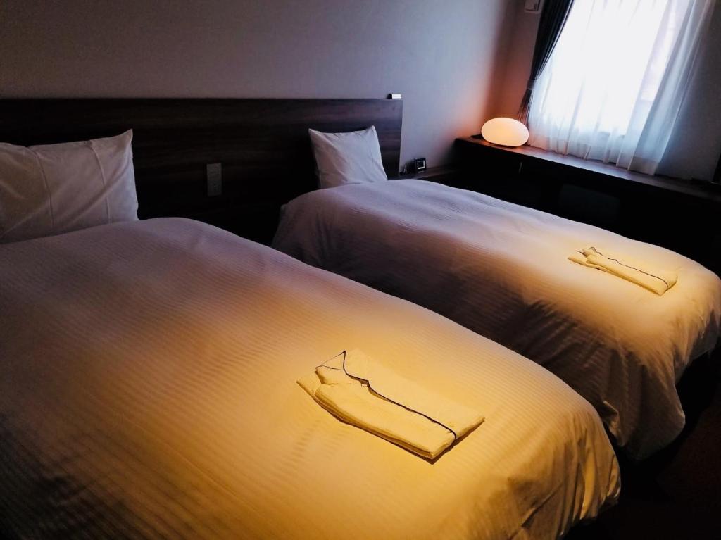 Postel nebo postele na pokoji v ubytování BRENZA HOTEL