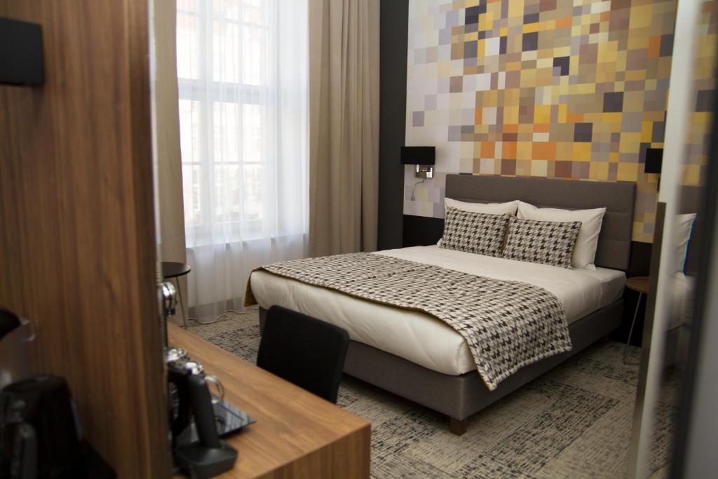 Postel nebo postele na pokoji v ubytování IBB Hotel Gdańsk