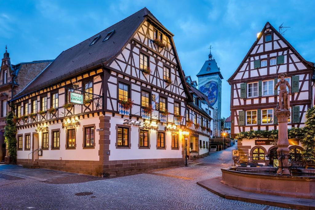 a building in a town with a clock tower at Hotel Krone in Bretten