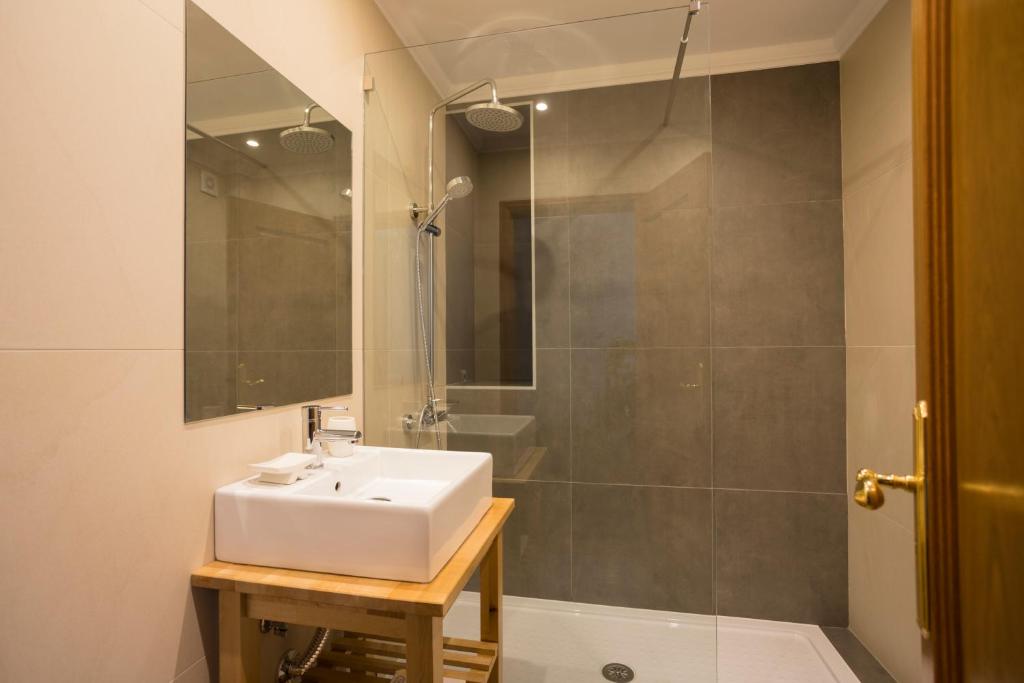 a bathroom with a sink and a shower at Ericeira Soul Guesthouse in Ericeira