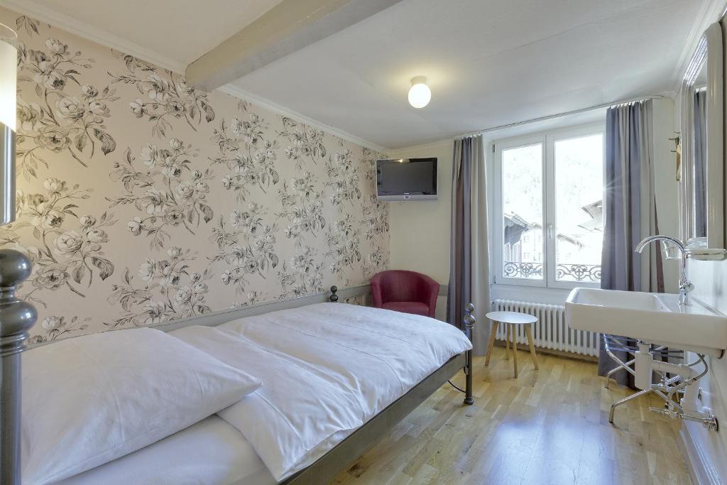 a hotel room with a bed and a sink at Alplodge in Interlaken