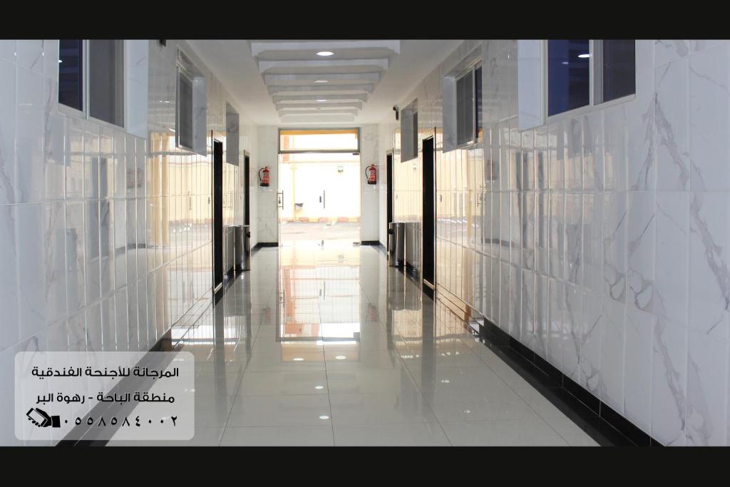 a hallway of a building with white walls and a hallwayngth at المرجانة للشقق المفروشه للعائلات Al Murjana Furnished Apartments for Families in Al Baha