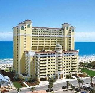 a large building on the beach next to the ocean at JeffsCondos - 1 Bedroom - Camelot Resort in Myrtle Beach