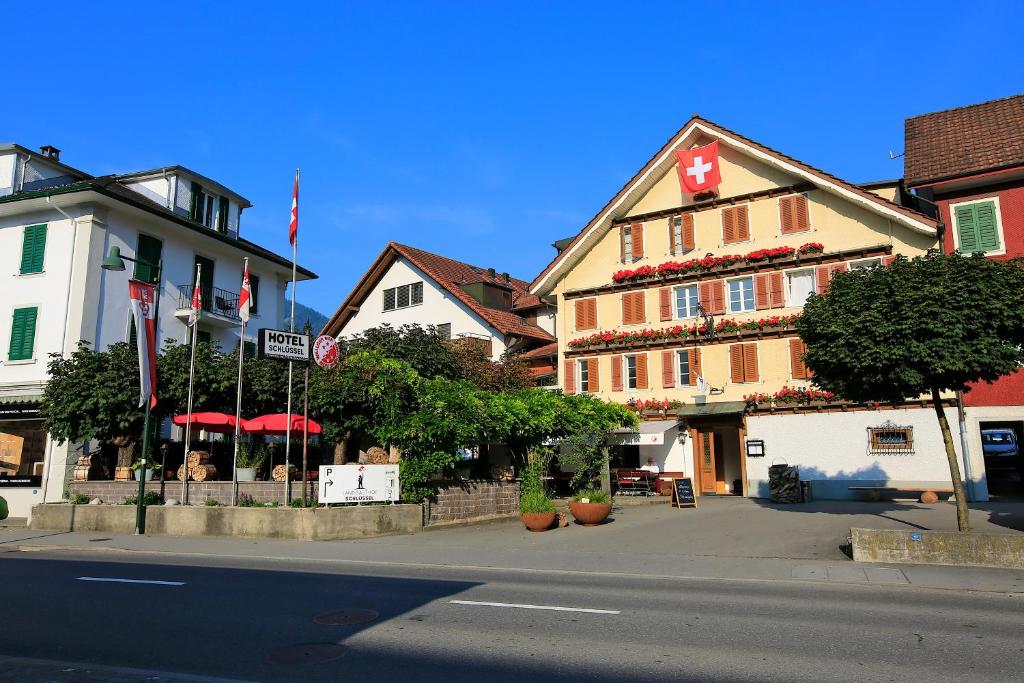 a street with a building with a cross on it at Landgasthof Schlüssel Alpnach in Alpnach