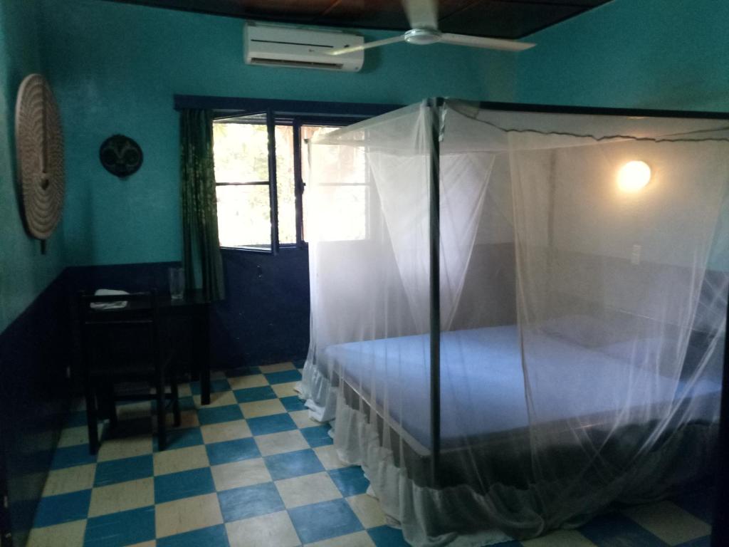 a bedroom with a bed with a mosquito net at Villa Bobo in Bobo-Dioulasso