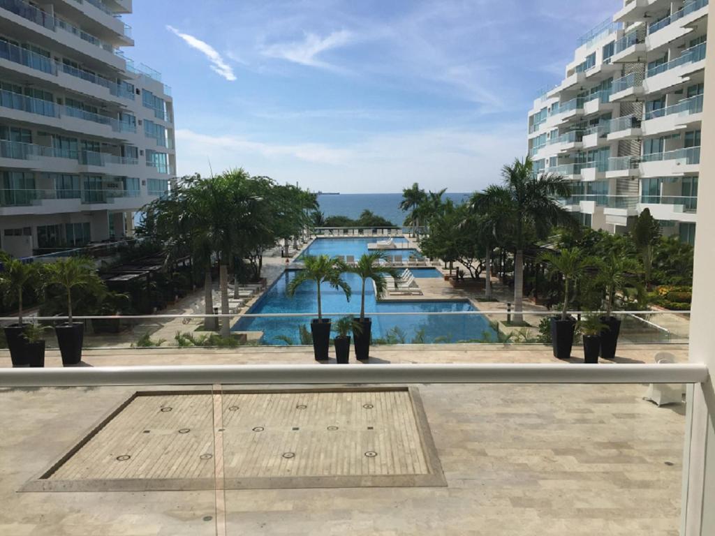 a view of a pool from the balcony of a building at Playa Dormida Santa Marta in Santa Marta