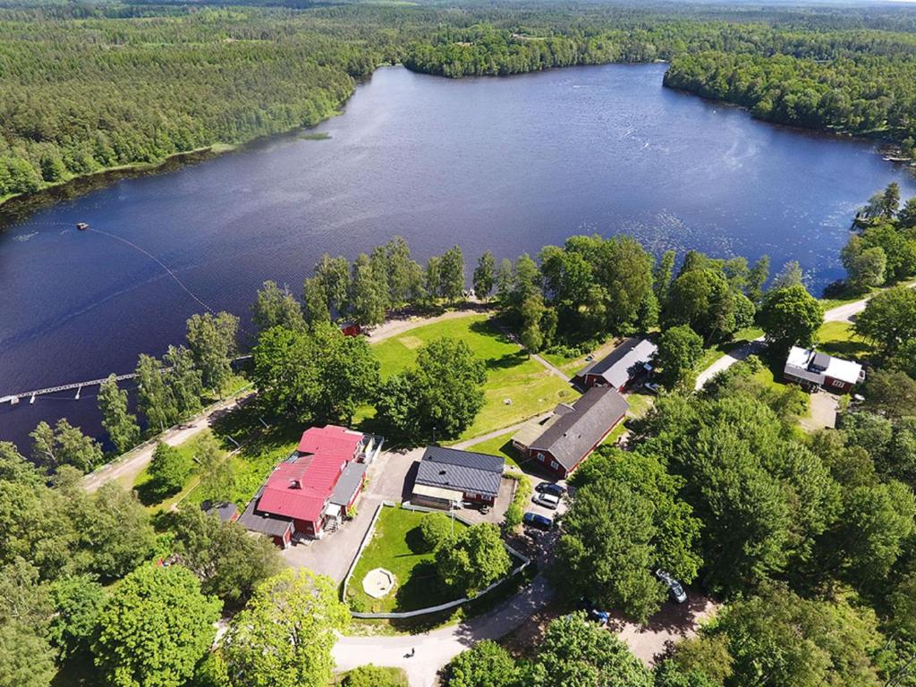 an aerial view of a building next to a lake at Den Sovande Älgen in Markaryd