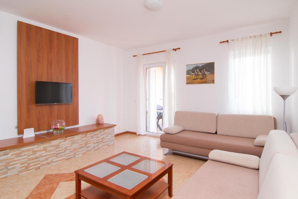 a living room with a couch and a table at Apartment Volme in Pula