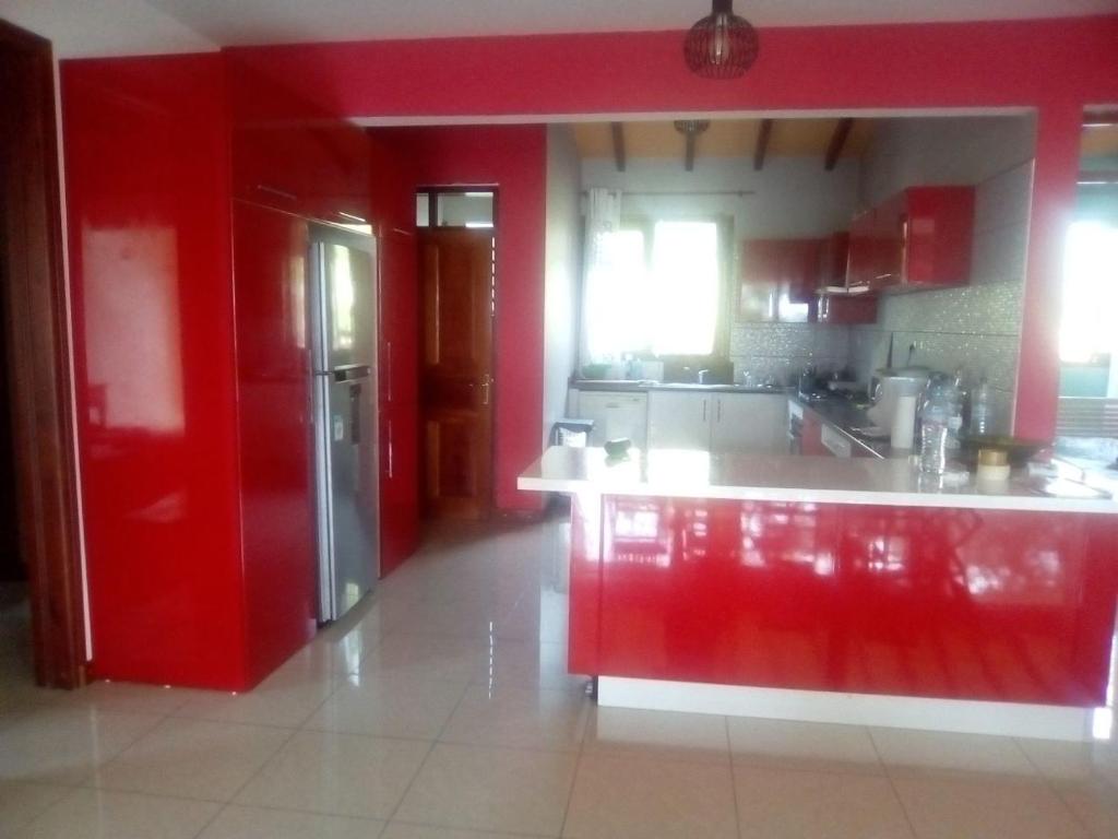 a kitchen with red walls and a red refrigerator at Villa Grand Case in Ferry