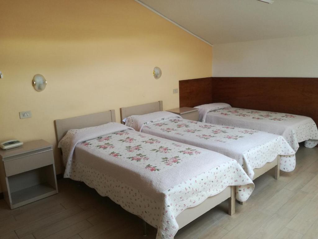 Postel nebo postele na pokoji v ubytování Hotel Prati